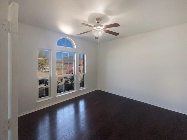 unfurnished room featuring dark hardwood / wood-style floors and ceiling fan