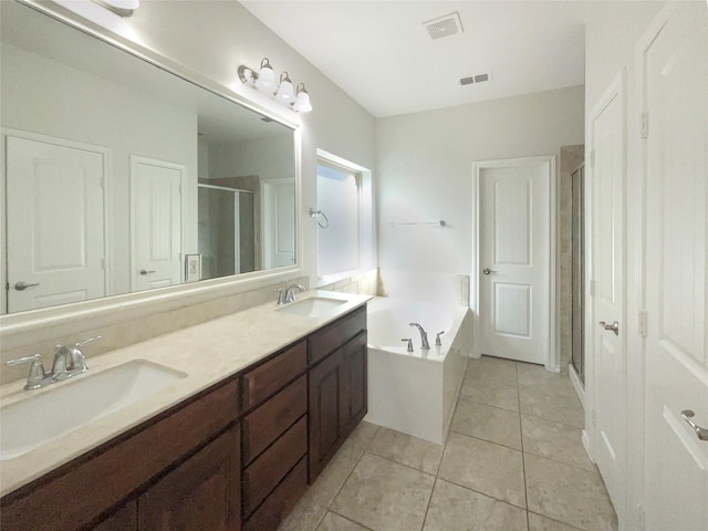 bathroom with vanity, plus walk in shower, and tile patterned flooring