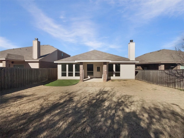 back of house with a yard and a patio area