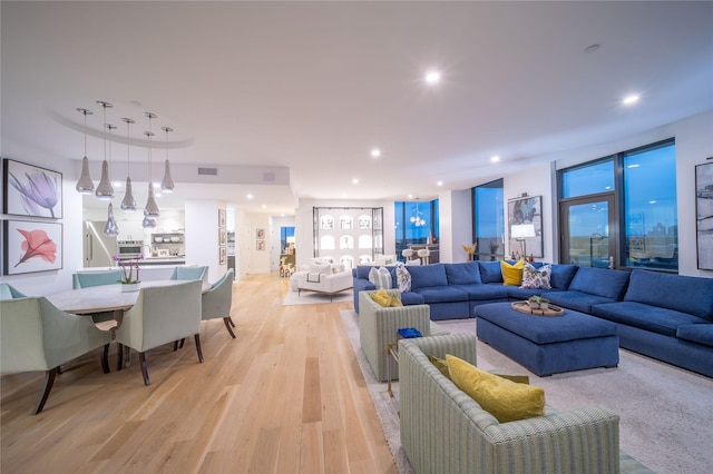 living room featuring light wood-style flooring, recessed lighting, and visible vents