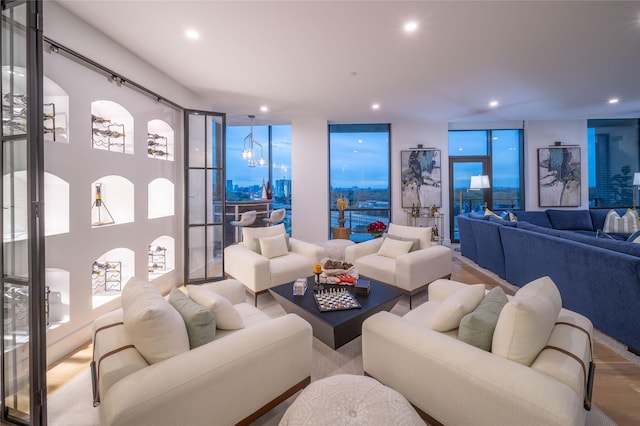 living area with wood finished floors, recessed lighting, and expansive windows