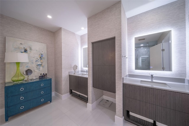 full bath featuring tile patterned flooring, visible vents, two vanities, a shower, and a sink