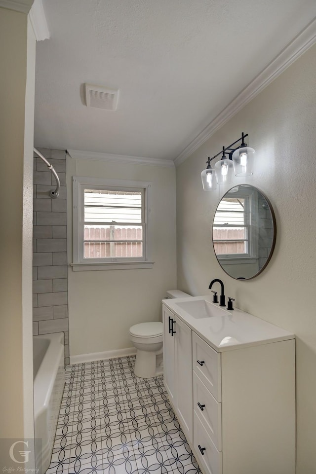 full bathroom featuring vanity, tiled shower / bath, ornamental molding, and toilet