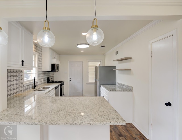 kitchen featuring stainless steel appliances, white cabinetry, pendant lighting, and kitchen peninsula