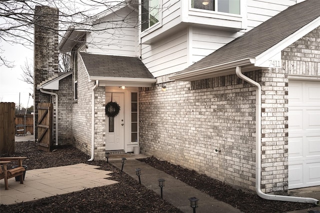 doorway to property with a garage