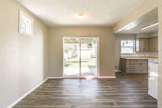 unfurnished room featuring a ceiling fan, visible vents, baseboards, and wood finished floors