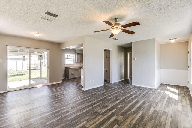 living room with baseboards, a textured ceiling, a ceiling fan, and wood finished floors