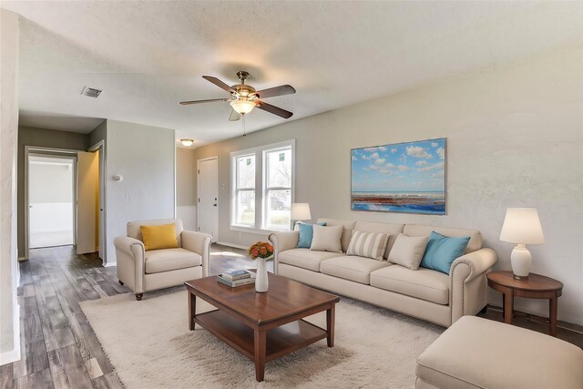 spare room featuring ceiling fan, dark wood-style flooring, a textured ceiling, and baseboards