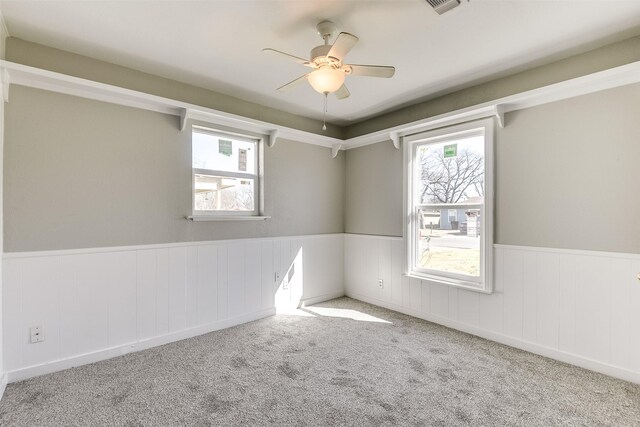 empty room with light carpet, a textured ceiling, and baseboards