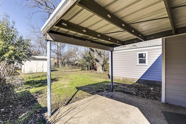 view of yard featuring an outbuilding, a patio area, and a storage shed