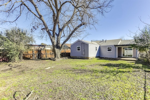 view of yard with fence and an outdoor structure