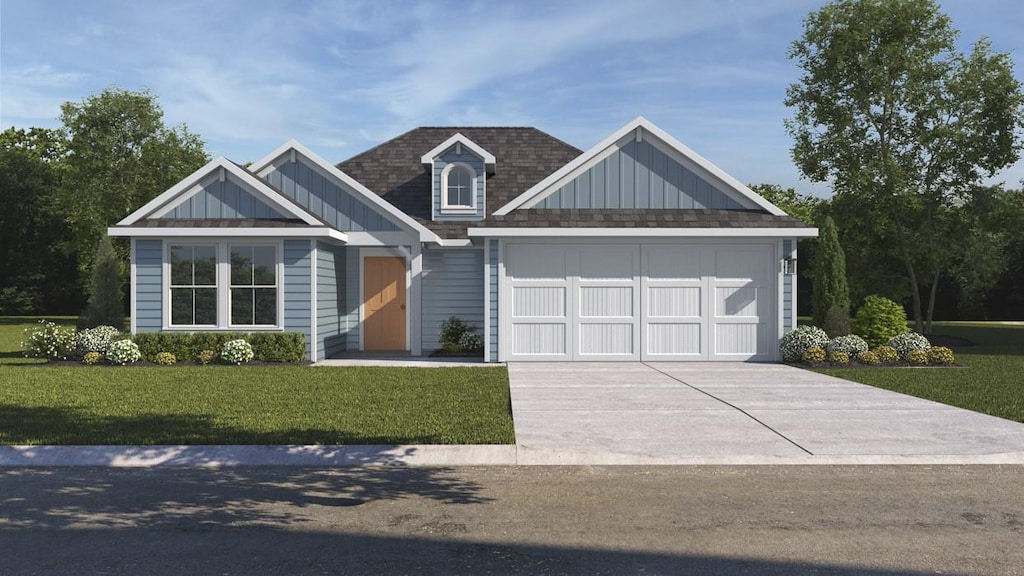 view of front of home featuring a garage and a front yard