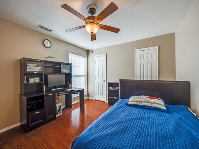 bedroom with ceiling fan, dark hardwood / wood-style floors, and a closet