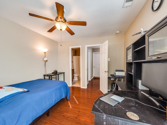 bedroom featuring dark wood-type flooring, ceiling fan, and connected bathroom