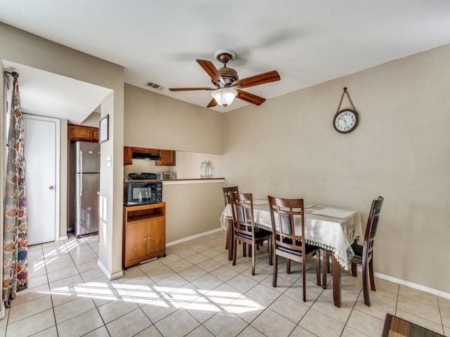 tiled dining area with ceiling fan