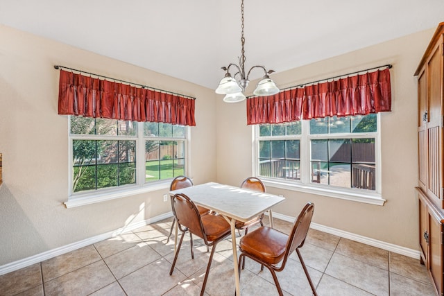 tiled dining area featuring a chandelier