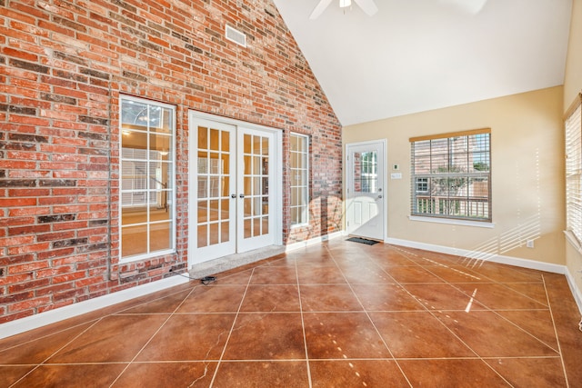 unfurnished sunroom featuring french doors, ceiling fan, and lofted ceiling