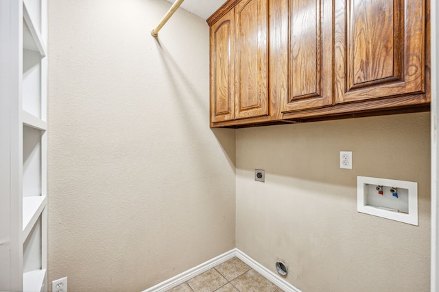 washroom with cabinets, light tile patterned flooring, hookup for a washing machine, and hookup for an electric dryer