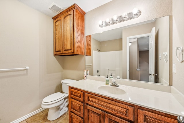 bathroom with vanity, toilet, tile patterned flooring, and a shower