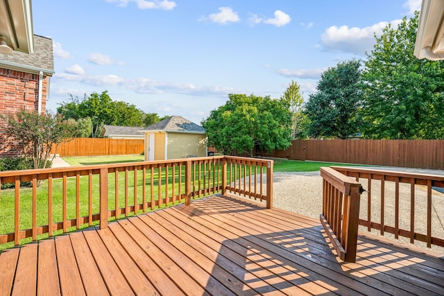 wooden deck featuring a shed and a yard