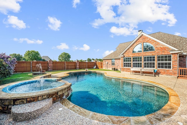 view of swimming pool with an in ground hot tub, pool water feature, and a patio area