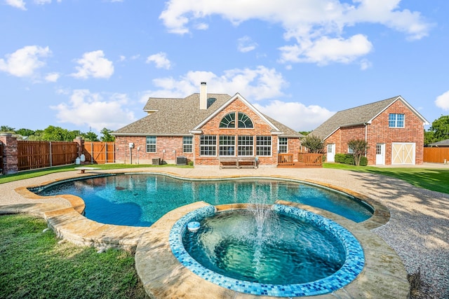 view of swimming pool with an in ground hot tub