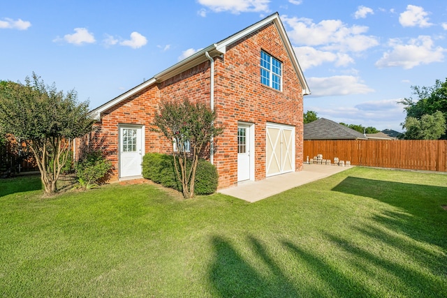 rear view of property with a patio and a yard