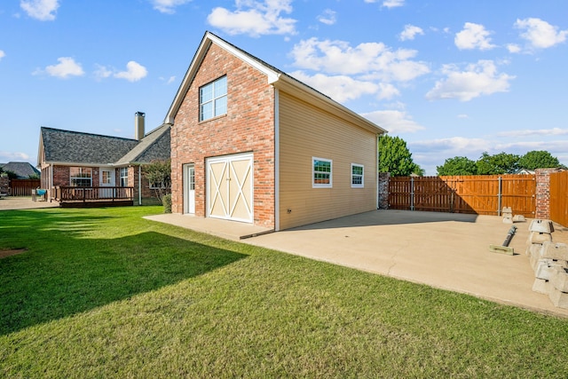 rear view of property with a lawn and a deck