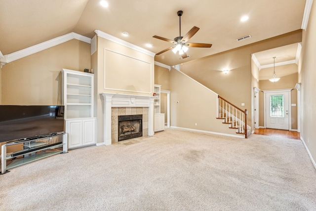 carpeted living room with a tiled fireplace, crown molding, high vaulted ceiling, and ceiling fan