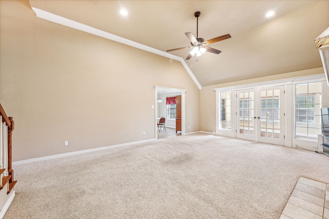 unfurnished living room featuring crown molding, high vaulted ceiling, light colored carpet, and ceiling fan