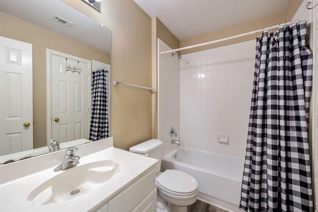 full bathroom featuring shower / tub combo with curtain, vanity, and toilet