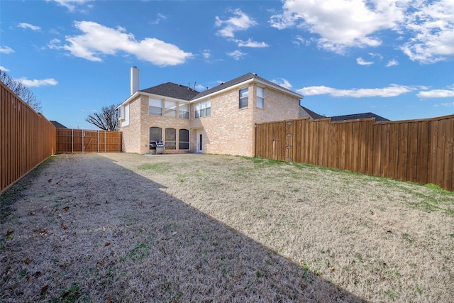 back of property featuring a lawn