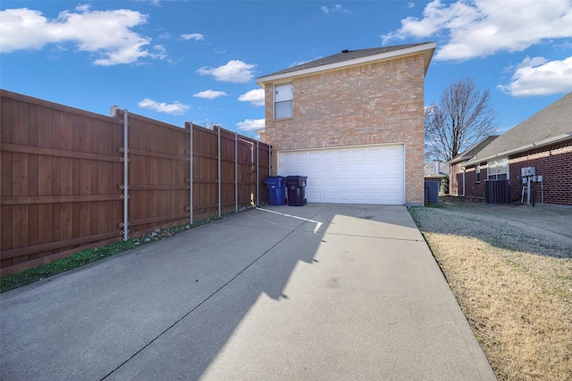 view of home's exterior with a garage and central air condition unit