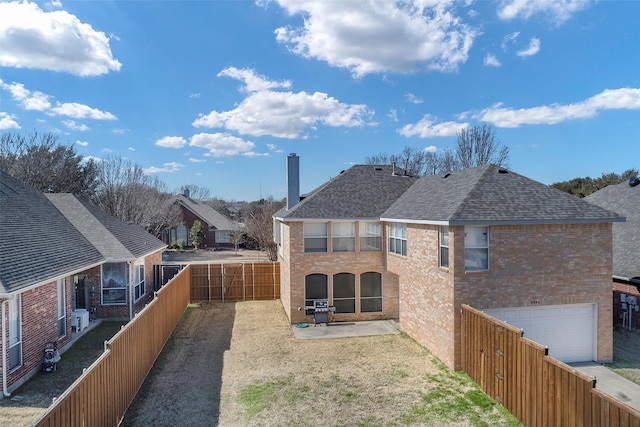 back of property featuring a garage and a patio