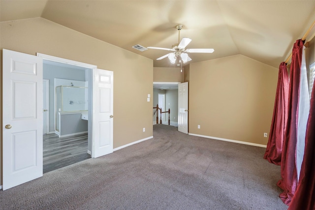 unfurnished bedroom with dark colored carpet, lofted ceiling, and ceiling fan