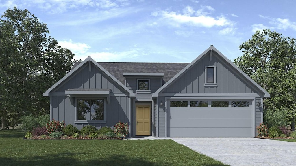 view of front of property featuring a garage and a front lawn