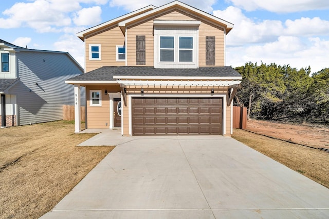 view of front of house with a garage and a front lawn