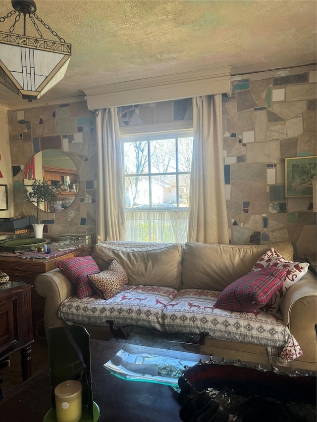 living room with ornamental molding and a textured ceiling