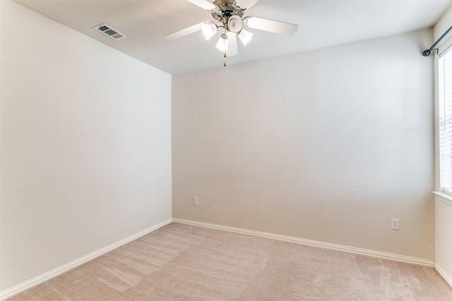 carpeted spare room with ceiling fan