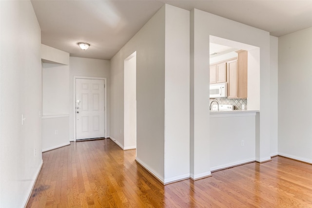 hall with light hardwood / wood-style flooring