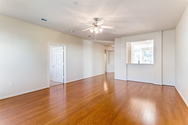 spare room with hardwood / wood-style floors and ceiling fan