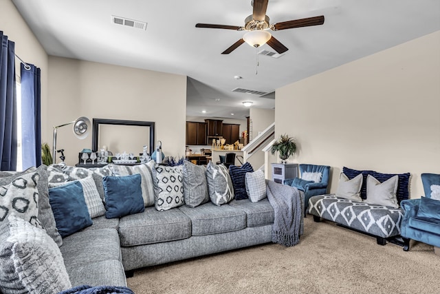 living room featuring ceiling fan and carpet