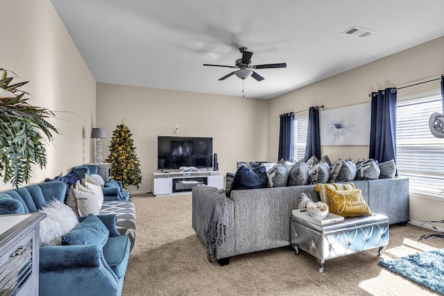 living room with light colored carpet and ceiling fan