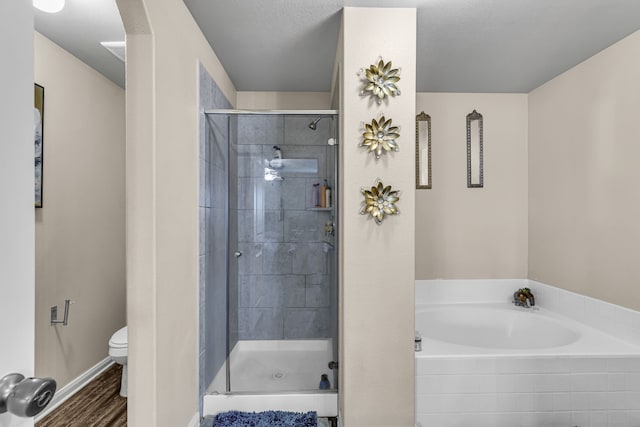 bathroom featuring hardwood / wood-style flooring, separate shower and tub, and toilet