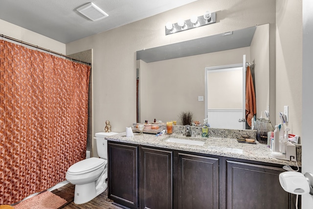 full bathroom with vanity, hardwood / wood-style floors, toilet, and shower / bathtub combination with curtain