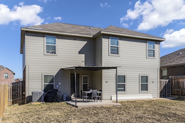 rear view of house featuring a patio, a yard, and central AC unit