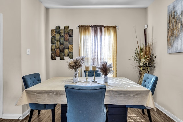 dining area with dark hardwood / wood-style flooring