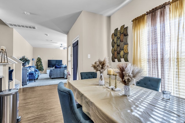 dining space featuring ceiling fan and carpet