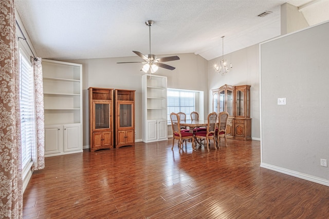 dining space with vaulted ceiling, ceiling fan with notable chandelier, a textured ceiling, and dark hardwood / wood-style flooring