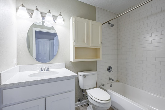 full bathroom featuring vanity, toilet, tiled shower / bath combo, and a textured ceiling